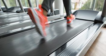 Runner on a treadmill with orange shoes