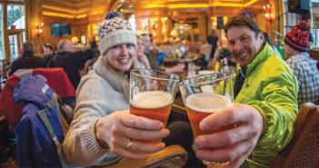 A couple enjoying beers at an après ski lodge Cinnabar