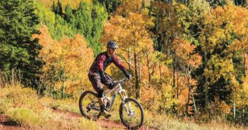 Mountain biker on a trail in the fall mountains
