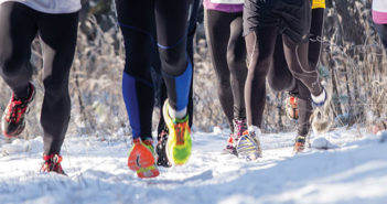 group of runners on a snowy trail