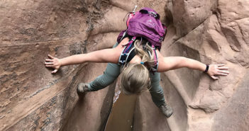 Woman Stemming down a narrow drop in Dang Canyon.
