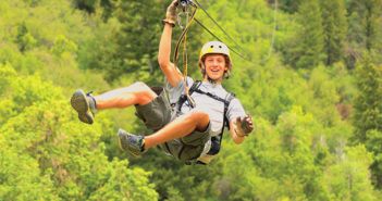 Man Ziplining with forest background