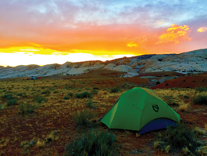 Tent in wilderness with sunset