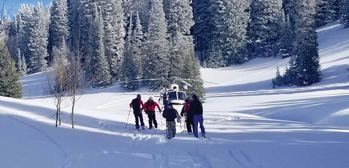 Search and rescue helicopter with a group of skiers