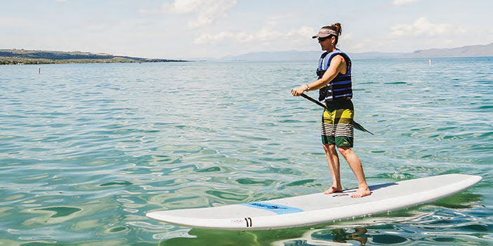 Woman paddleboarding on a lake
